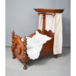 A Victorian child's / dolls canopy bed, mahogany, with original Victorian bedding including hand