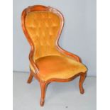 A Victorian mahogany framed nursing chair, with velvet upholstered buttoned back.