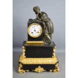 An early 19th century French ormolu and black marble mantle clock, surmounted by bronze figure, 46cm