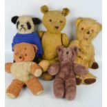 A group of vintage teddy bears some straw filled