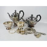A silver plated tea set, silver plated hand mirror, ring sizer, two silver napkin rings, silver