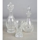 Two cut glass decanters and a vase.