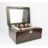 A 19th century coromandel and brass inlaid vanity box, with mirrored interior, silver plated