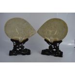 A pair of 19th century Cantonese mother of pearl shells, carved with fish and figures, raised on