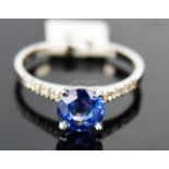A 18ct white gold, diamond, and blue sapphire ring, 1.2ct sapphire with diamonds set to shoulders,