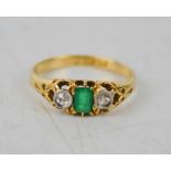 An 18ct gold, emerald and diamond ring, size L/M, with rectangular cut emerald, 3.2g.