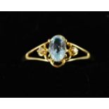 A 9ct gold ring set with blue topaz and diamonds, size O.
