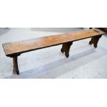 An antique long wooden bench. 46cm h x 242cm x 31