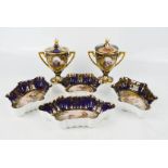 A group of four Royal Vienna dishes, two cups and covers, twin handles, with cobalt blue ground,