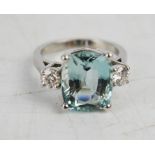 An aquamarine, diamond and platinum ring, the 6ct aquamarine flanked by brilliant cut diamonds