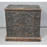 A carved oak chest with iron handles, the front depicting birds.