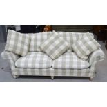 A two seater settee with checkered cotton upholstery, and cushions.