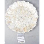 A Gujarat mother of pearl dish, composed of segments. held together with pins, 28cm diameter.