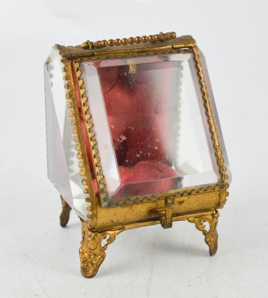 An antique French pocket watch case, with bevelled glass panels and gilt metal border, 10cm high.