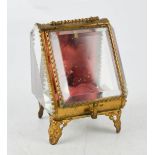 An antique French pocket watch case, with bevelled glass panels and gilt metal border, 10cm high.