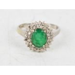 A 9ct gold, diamond and emerald ring, size R/S, 3.6g.