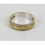 A 9ct white and yellow gold band ring set with thirty four diamonds, (unmarked), 5.6g.
