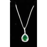 An 18ct white gold, diamond and emerald pear shaped pendant necklace.