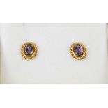 A pair of 9ct gold and amethyst stud earrings.