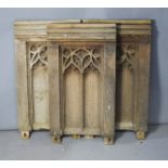 Three antique pew ends, carved with Gothic tracery.