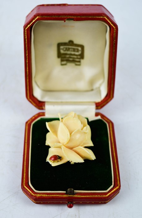 A finely carved rose form brooch, with 18ct gold (tested) mount, and enamelled ladybird set to the