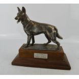 A WWII commemorative model Alsation raised on a plinth, silvered metal, bearing plaque engraved