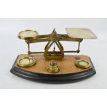 An antique set of brass scales, complete with weights.