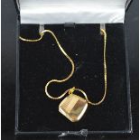 A 9ct gold chain and locket, 15 inch chain.