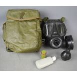 A 1972 Gas Mask in bag together with a filter.