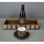 A Hundertwasser design box, bottle, cup and saucer.