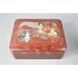 A Chinese red lacquered and mother of pearl inlaid jewellery box, containing jewellery.