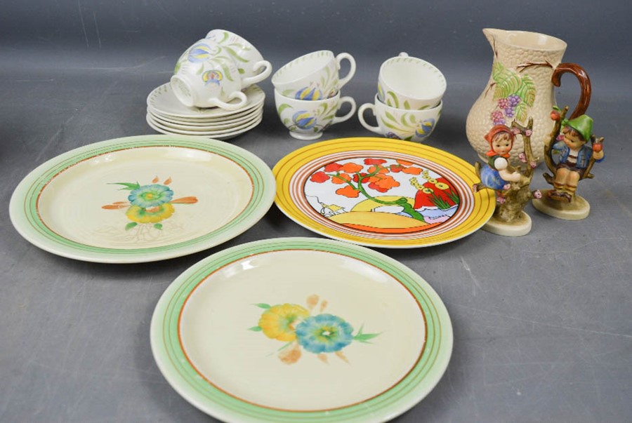 A Clarice Cliff Bizarre pattern plate, and two Hummel figures, a Wade jug, and two Clarice Cliff