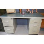 A mid-century metal pedestal desk.