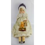 A vintage doll dressed in a lace gown, a Victorian Dolly's feeding bottle, boxed and a small teddy