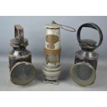 Three antique railway lanterns.