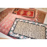 A group of four Persian rugs.