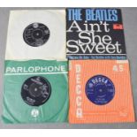 Four 7" singles; The Beatles She Loves You, The Beatles Ain't She Sweet, Elvis Presley Lonely Man,