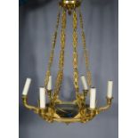 A brass chandelier, with six branches, hung from four chains.