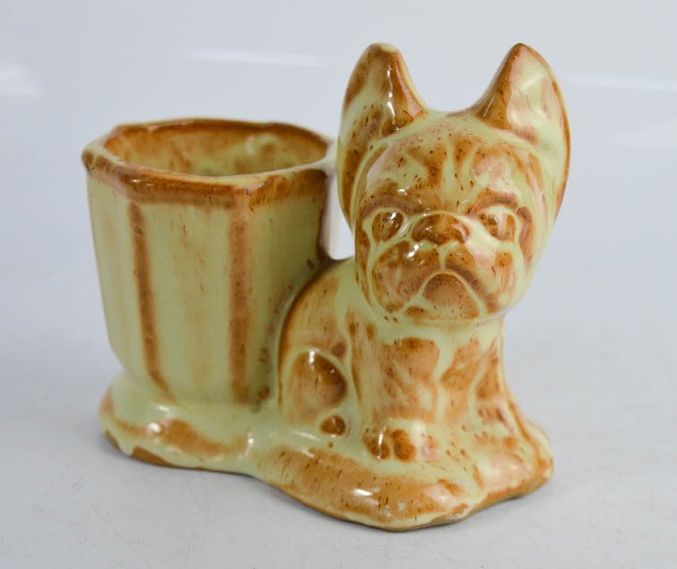 A ceramic match pot; Bonzo the dog.