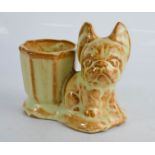 A ceramic match pot; Bonzo the dog.