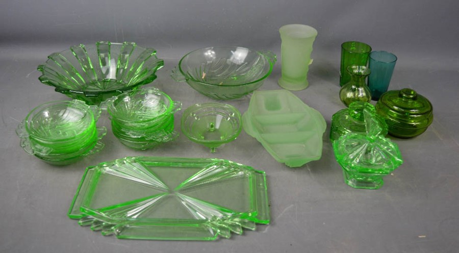 A group of green retro glassware, including pressed glass bowls, tray, dishes and fruit bowls.