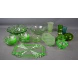 A group of green retro glassware, including pressed glass bowls, tray, dishes and fruit bowls.