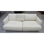 A two seater white leather settee.