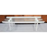 A retro white painted coffee table with glass top.