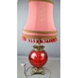 A red glass bohemian style table lamp, with red shade.