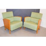Two beech mid century armchairs, with green upholstery.