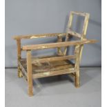 A wooden framed child's reclining armchair. A/F