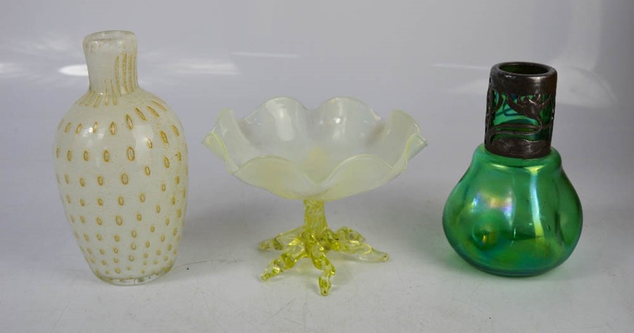 An iridescent bottle, Art Nouveau style metal rim, an opaque glass dish and a vase.