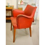 A mid century red leather chair.