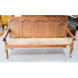 A Georgian oak settle, with a panel back, raised on short cabriole legs. A/F